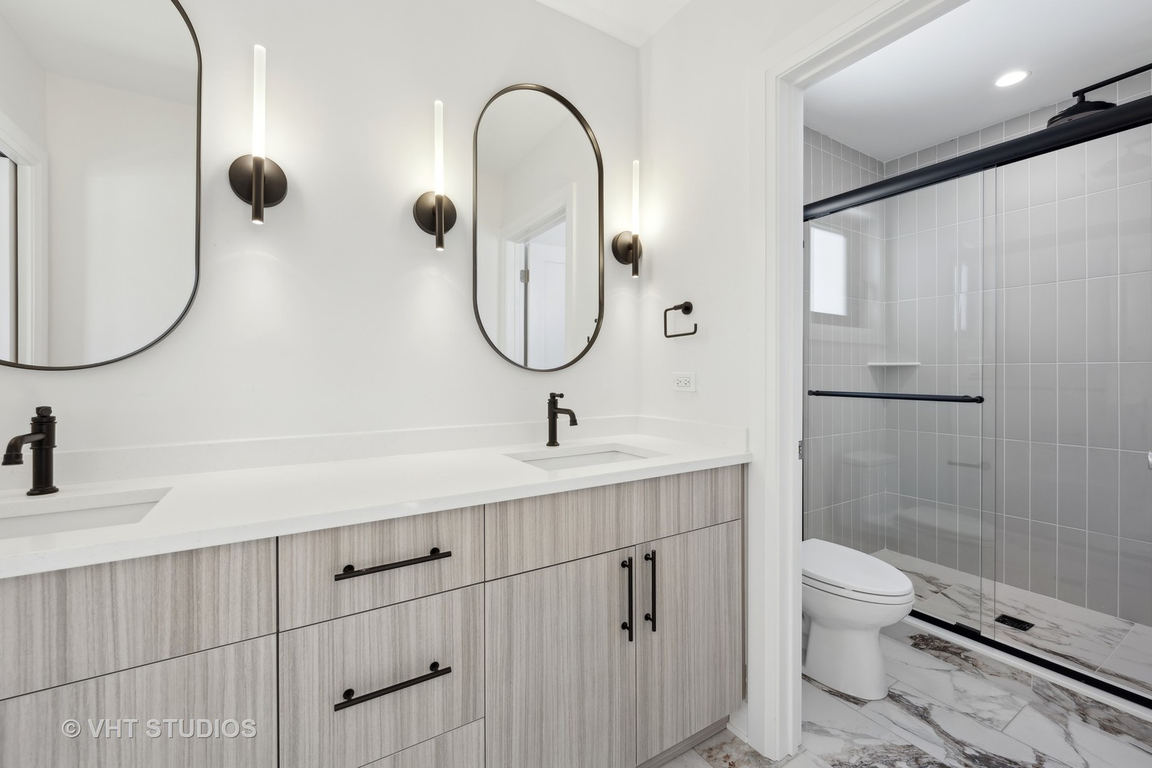 399 Ridge Avenue Winnetka, IL 60093 - Photo 34 of 45 a bathroom with a double vanity sink a toilet and a shower