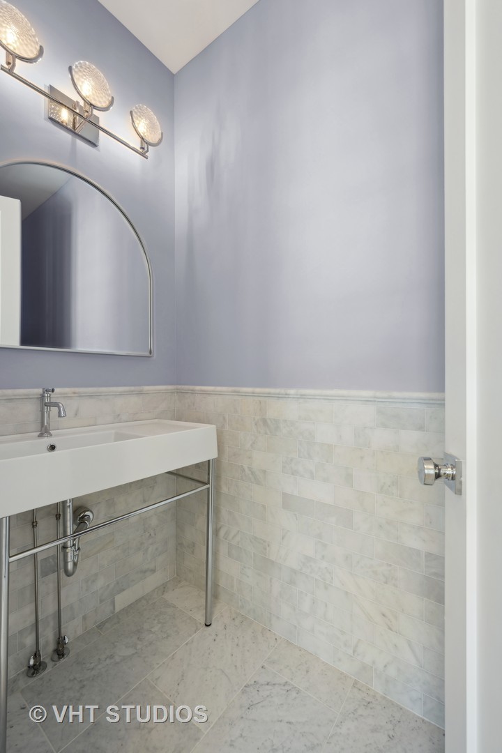 399 Ridge Avenue Winnetka, IL 60093 - Photo 40 of 45 a bathroom with a sink a vanity and a mirror