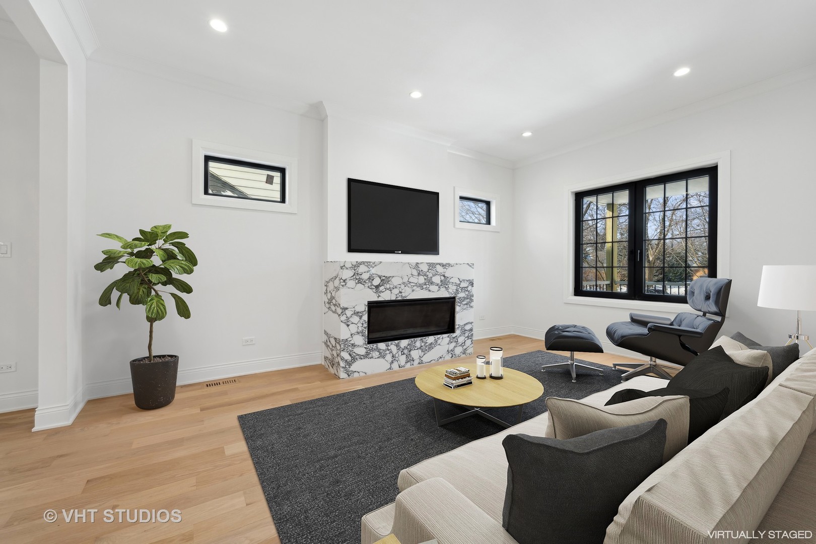 399 Ridge Avenue Winnetka, IL 60093 - Photo 5 of 45 a living room with furniture a fireplace and a flat screen tv
