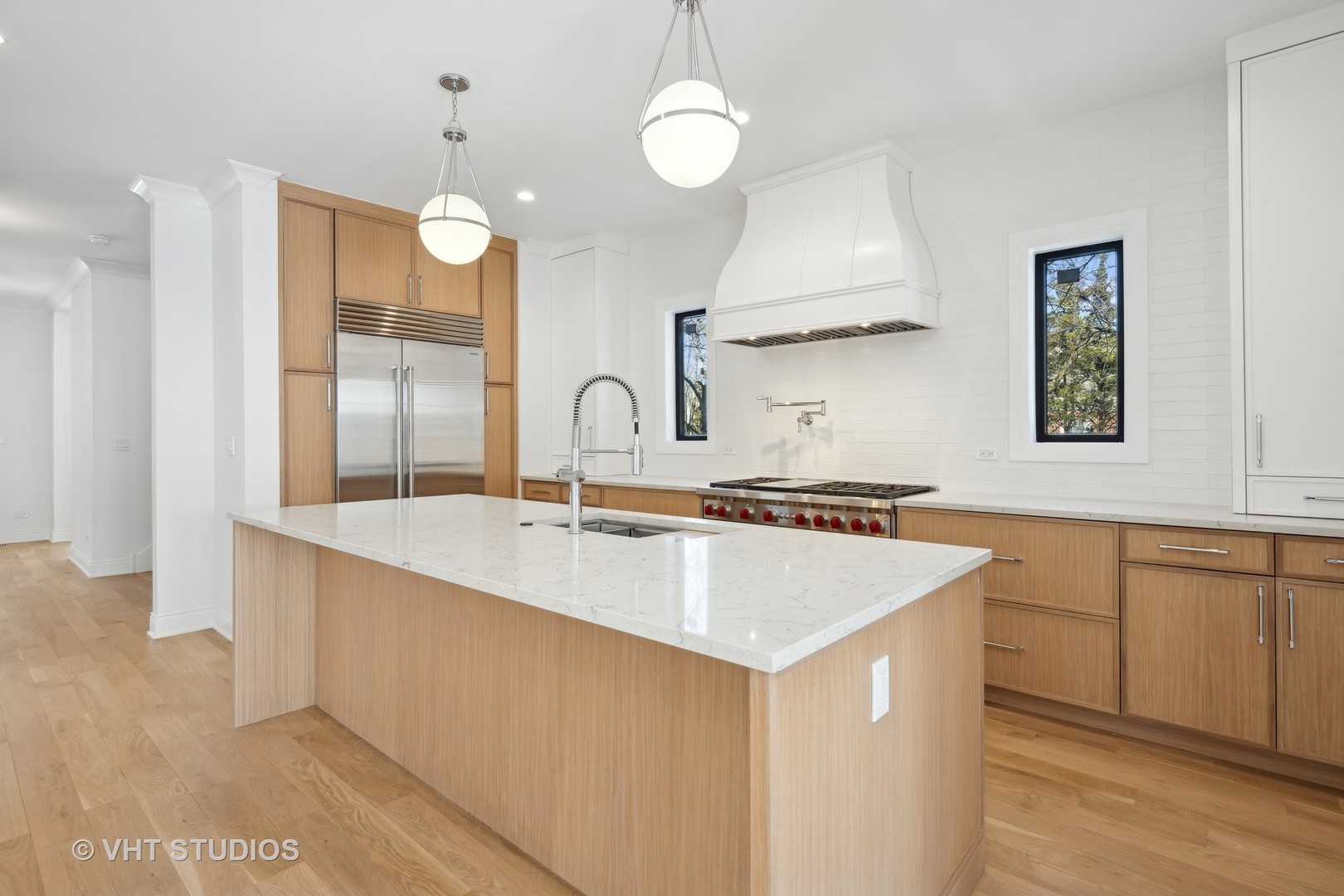 399 Ridge Avenue Winnetka, IL 60093 - Photo 9 of 45 a large kitchen with sink a counter space and a refrigerator