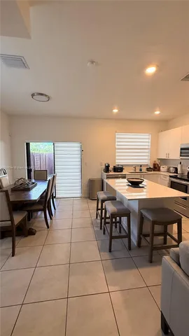 a room with furniture pool table and two windows