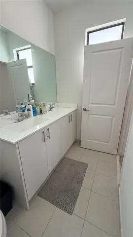 a room with a sink and cabinets