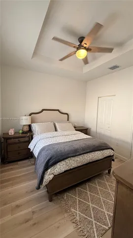 a bedroom with a bed and a chandelier