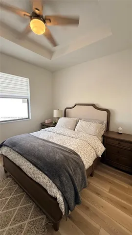 a bedroom with a bed and a chandelier