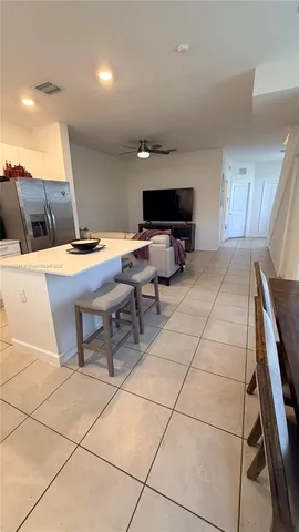 a room with furniture a flat screen tv and a table