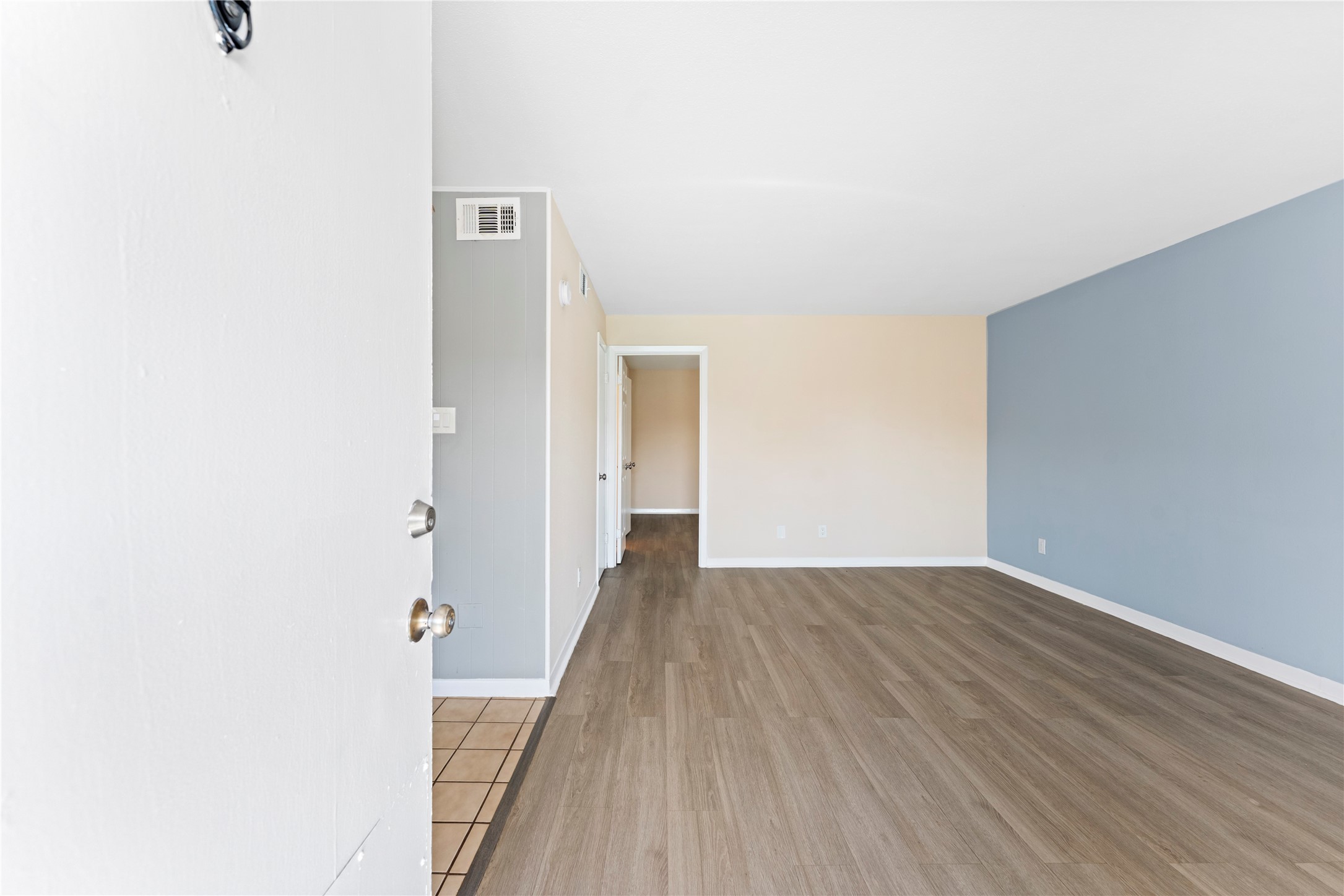 3316 Burke Road, Unit 43 Pasadena, TX 77504 - Photo 2 of 15 a view of a hallway with wooden floor