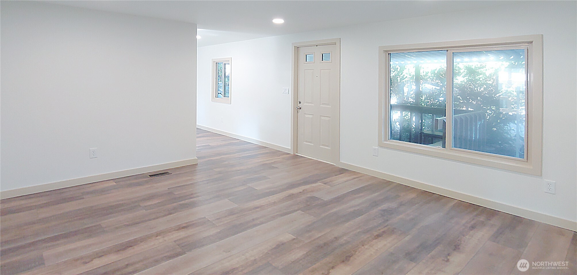 3504 Seattle Hill Road, Unit 30 Bothell, WA 98012 - Photo 11 of 23 an empty room with wooden floor and windows