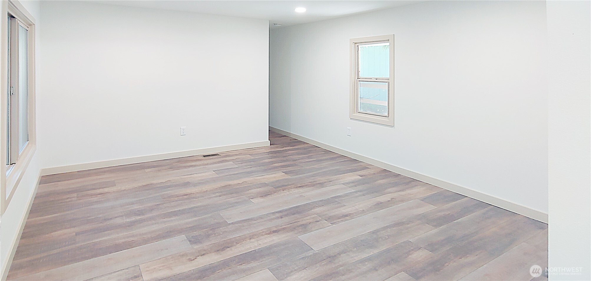 3504 Seattle Hill Road, Unit 30 Bothell, WA 98012 - Photo 12 of 23 an empty room with wooden floor and windows