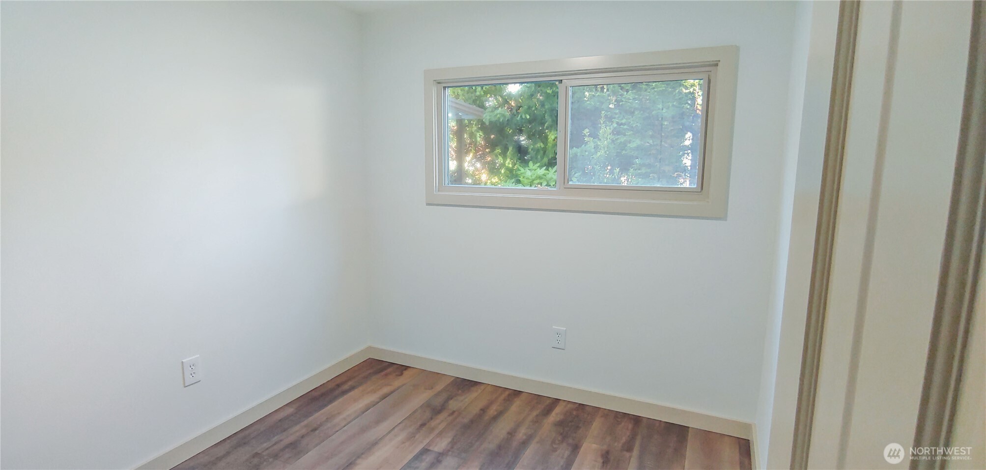 3504 Seattle Hill Road, Unit 30 Bothell, WA 98012 - Photo 8 of 23 a view of an empty room with wooden floor and windows