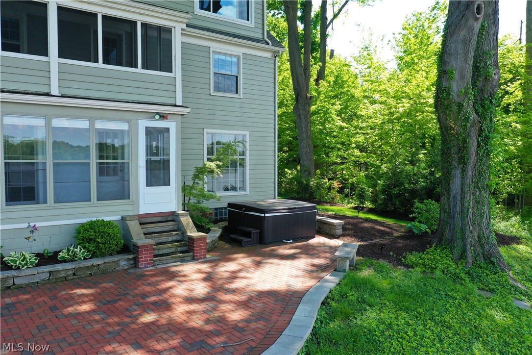 7421 Diagonal Road Kent, OH 44240 - Photo 40 of 48 showing both the glass porch, screen porch, brick patio & hot tub