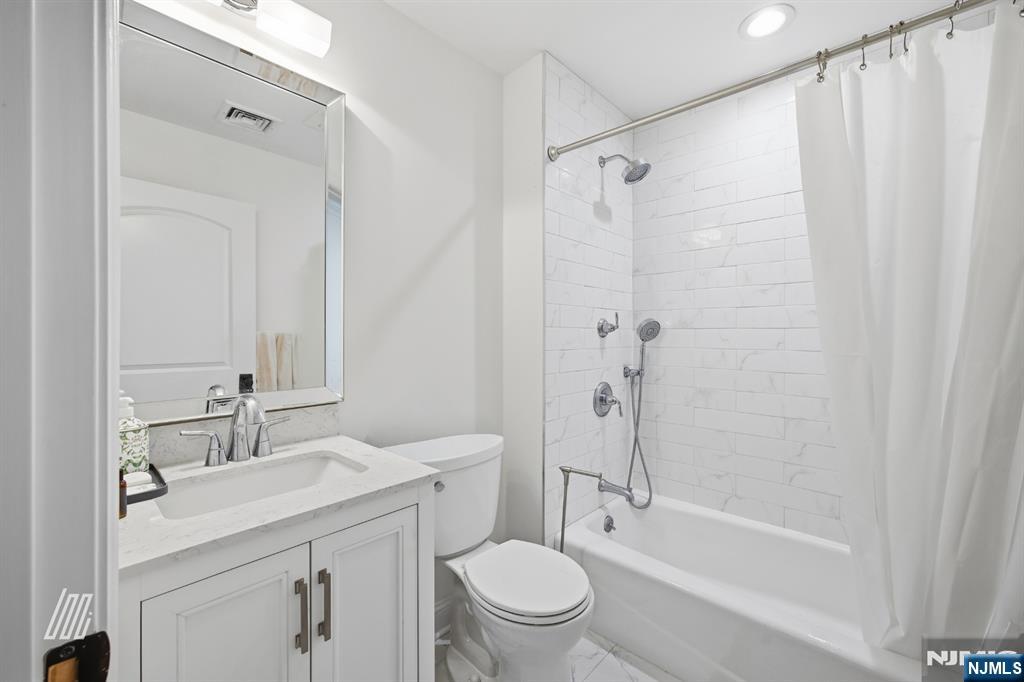 8 Ranch Lane Closter, NJ 07624 - Photo 19 of 36 a bathroom with a granite countertop sink a toilet and shower