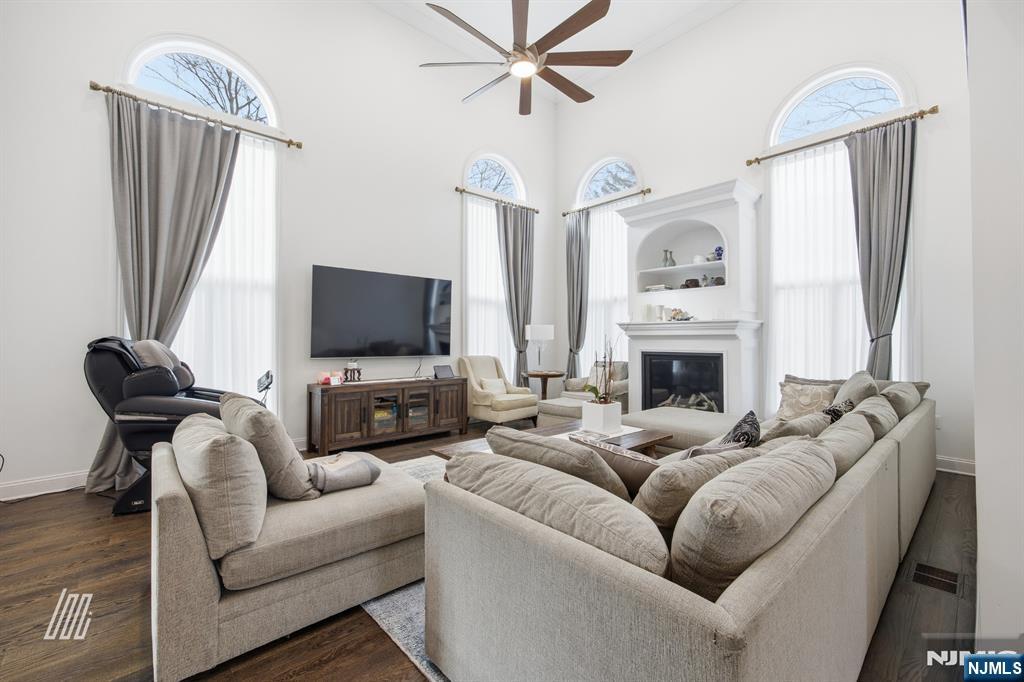 8 Ranch Lane Closter, NJ 07624 - Photo 9 of 36 a living room with furniture a fireplace and a flat screen tv