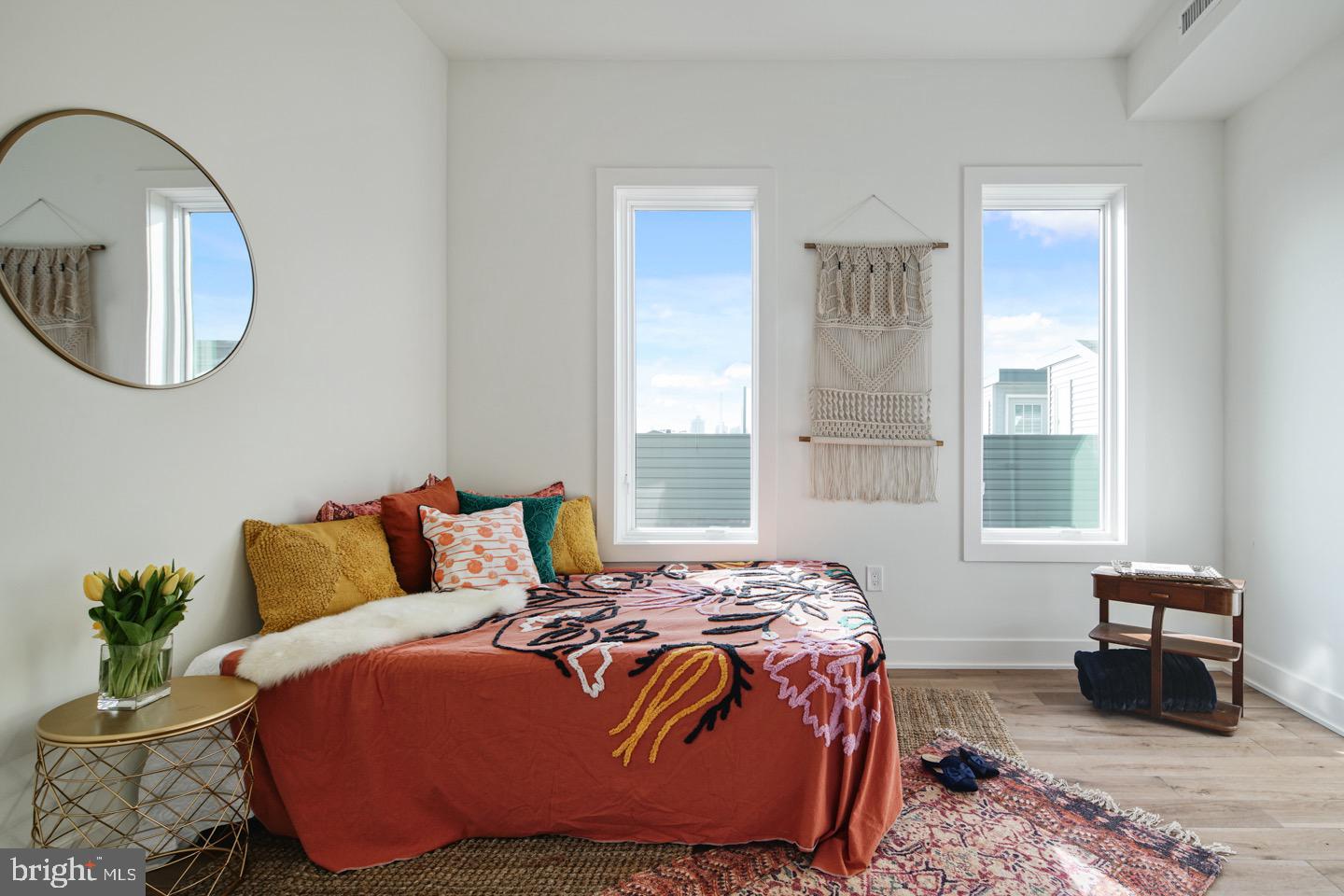 1822 North Front Street, Unit 8 Philadelphia, PA 19122 - Photo 18 of 23 a bedroom with a bed a mirror and a window