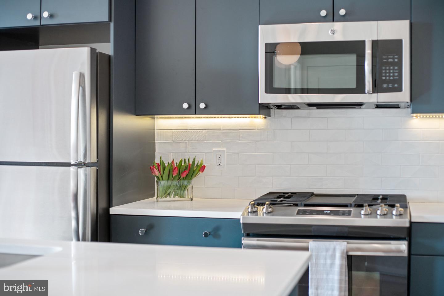 1822 North Front Street, Unit 8 Philadelphia, PA 19122 - Photo 8 of 23 a kitchen with a stove and a refrigerator