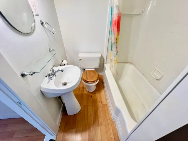 a bathroom with a sink toilet and shower