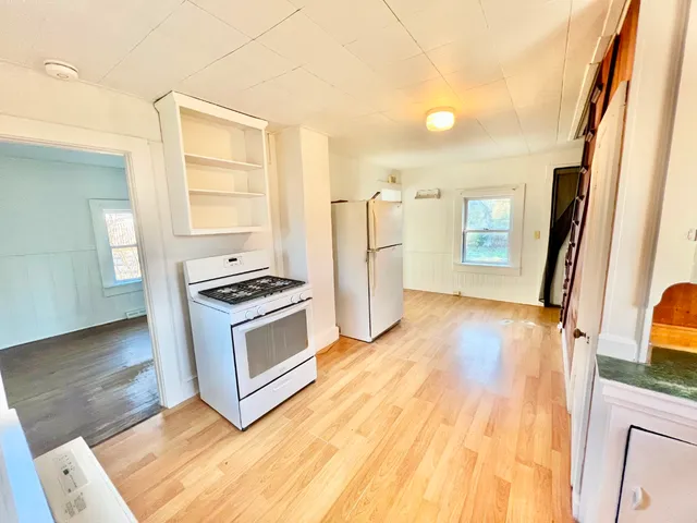 a kitchen with stainless steel appliances a stove top oven a sink and a refrigerator