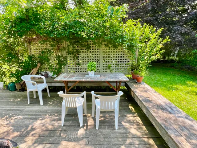 a view of a chairs and table in the patio