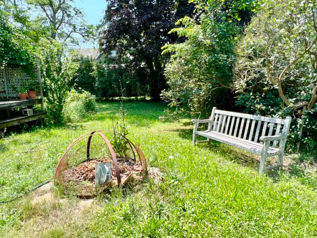 a view of a chair and table in the garden