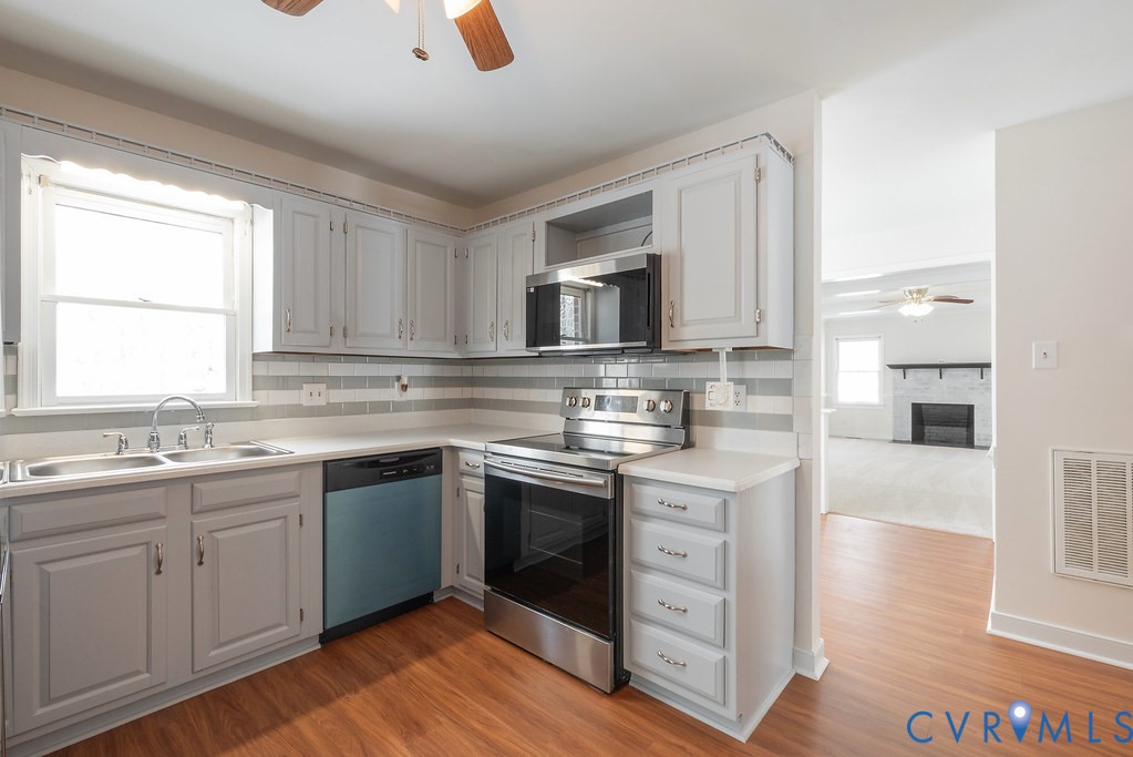 10510 Courtney Road Glen Allen, VA 23060 - Photo 12 of 44 a kitchen with a sink stove and cabinets