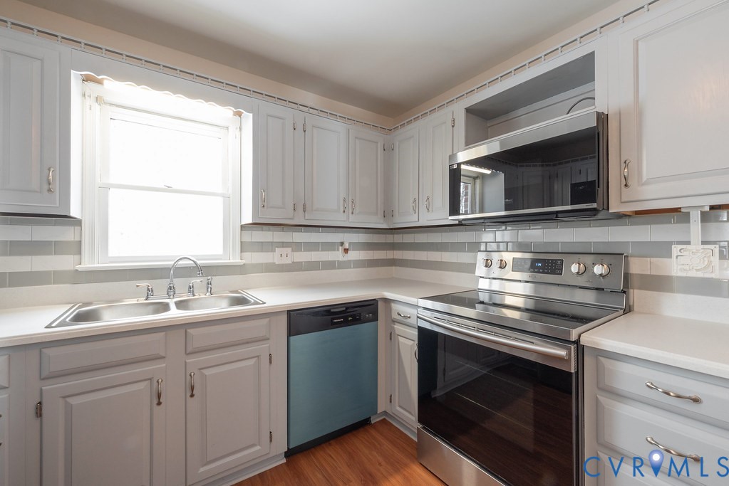 10510 Courtney Road Glen Allen, VA 23060 - Photo 14 of 44 a kitchen with cabinets stainless steel appliances a sink and a window
