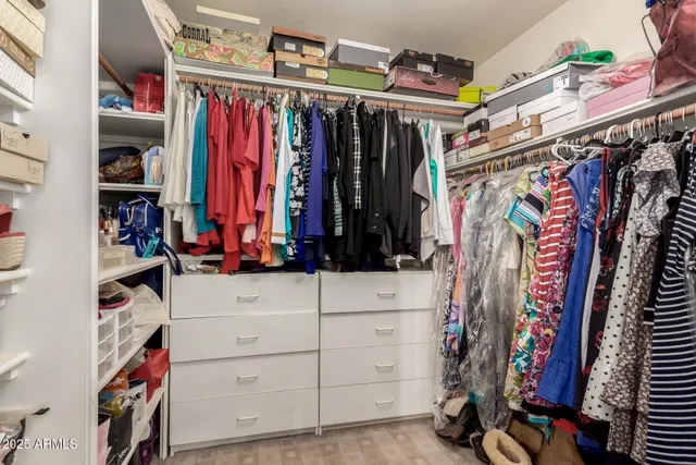 a bedroom with a bed and a flat tv screen