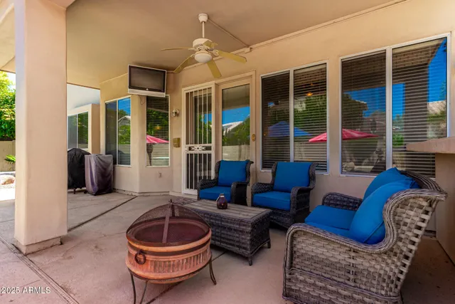 a view of a house with swimming pool and sitting area