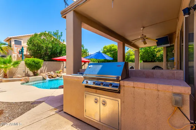 a view of a white house with a yard and potted plants