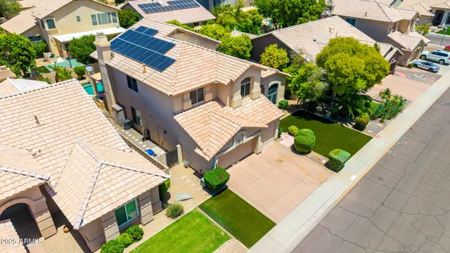 an aerial view of a house with a yard and garden