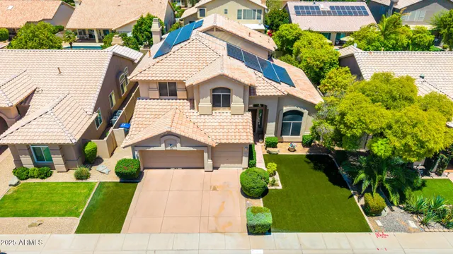 a view of a house with a backyard