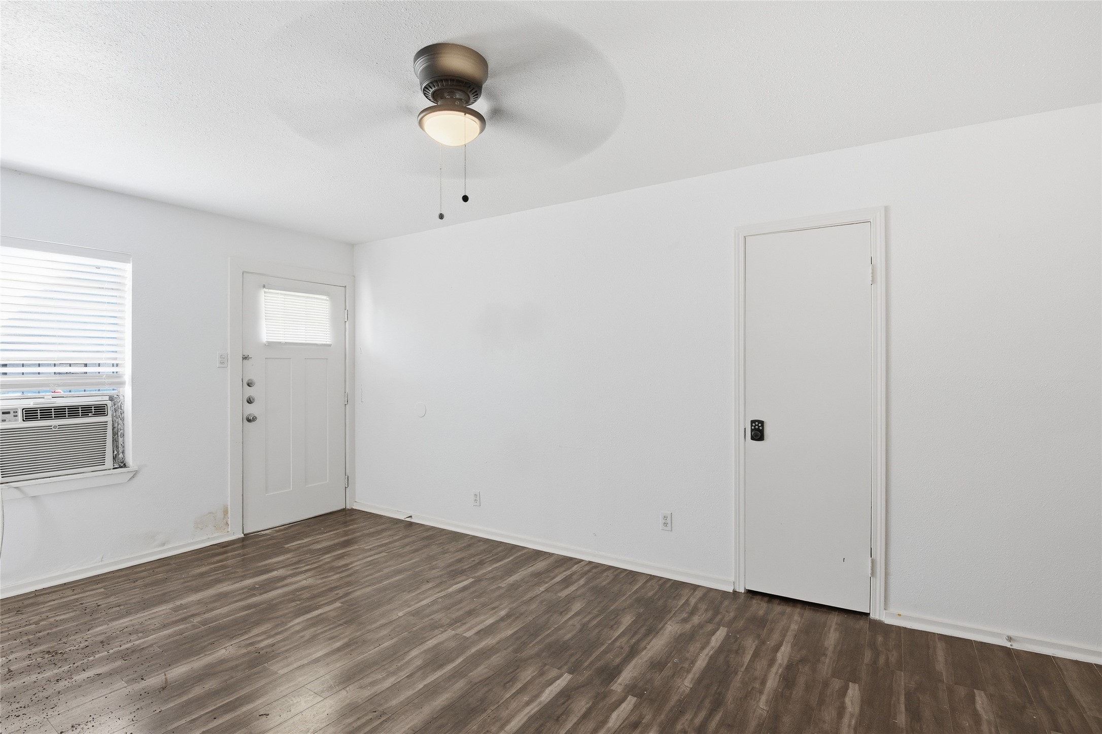 5010 Ennis Street, Unit 2 Houston, TX 77004 - Photo 2 of 11 an empty room with wooden floor and windows