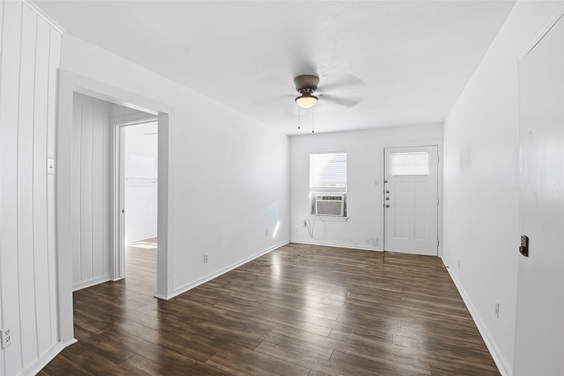 5010 Ennis Street, Unit 2 Houston, TX 77004 - Photo 3 of 11 an empty room with wooden floor and windows