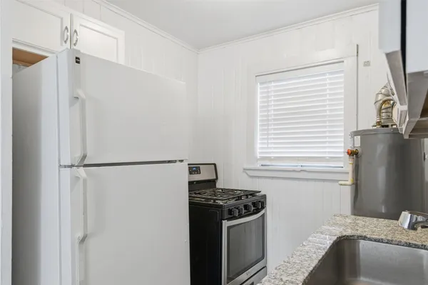 a kitchen with a refrigerator stove and sink