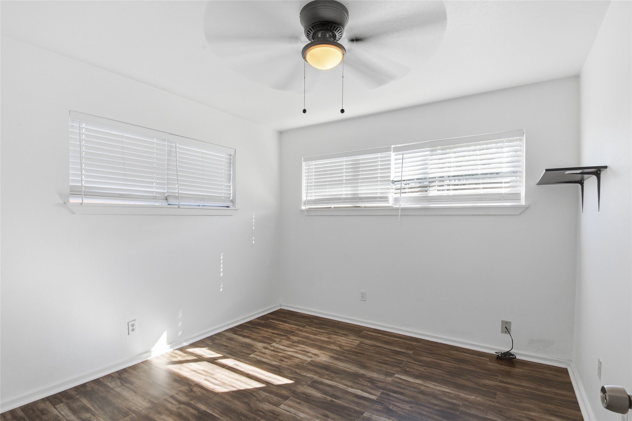 5010 Ennis Street, Unit 2 Houston, TX 77004 - Photo 10 of 11 a view of an empty room with wooden floor and a window
