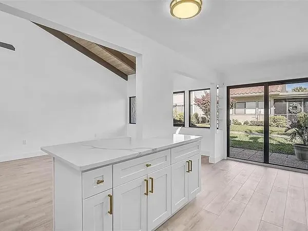 a spacious bathroom with a granite countertop sink and a window
