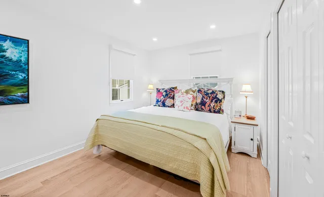 a spacious bedroom with a bed and a window