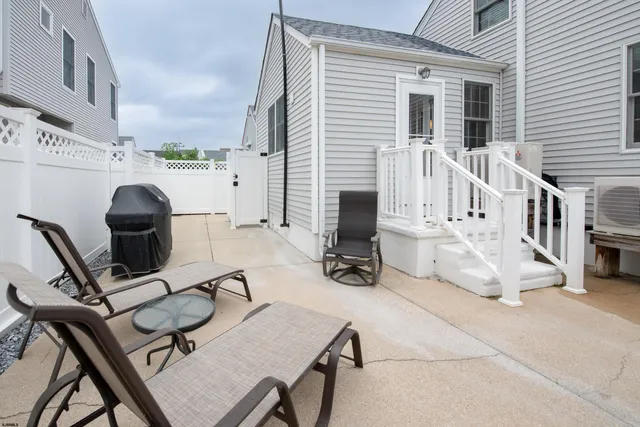 a view of a workspace with furniture and a large window