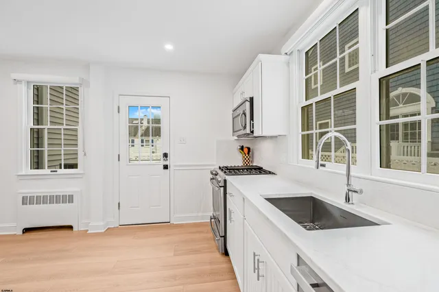 a kitchen with a sink stove and cabinets
