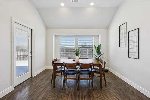 a dining room with furniture and wooden floor