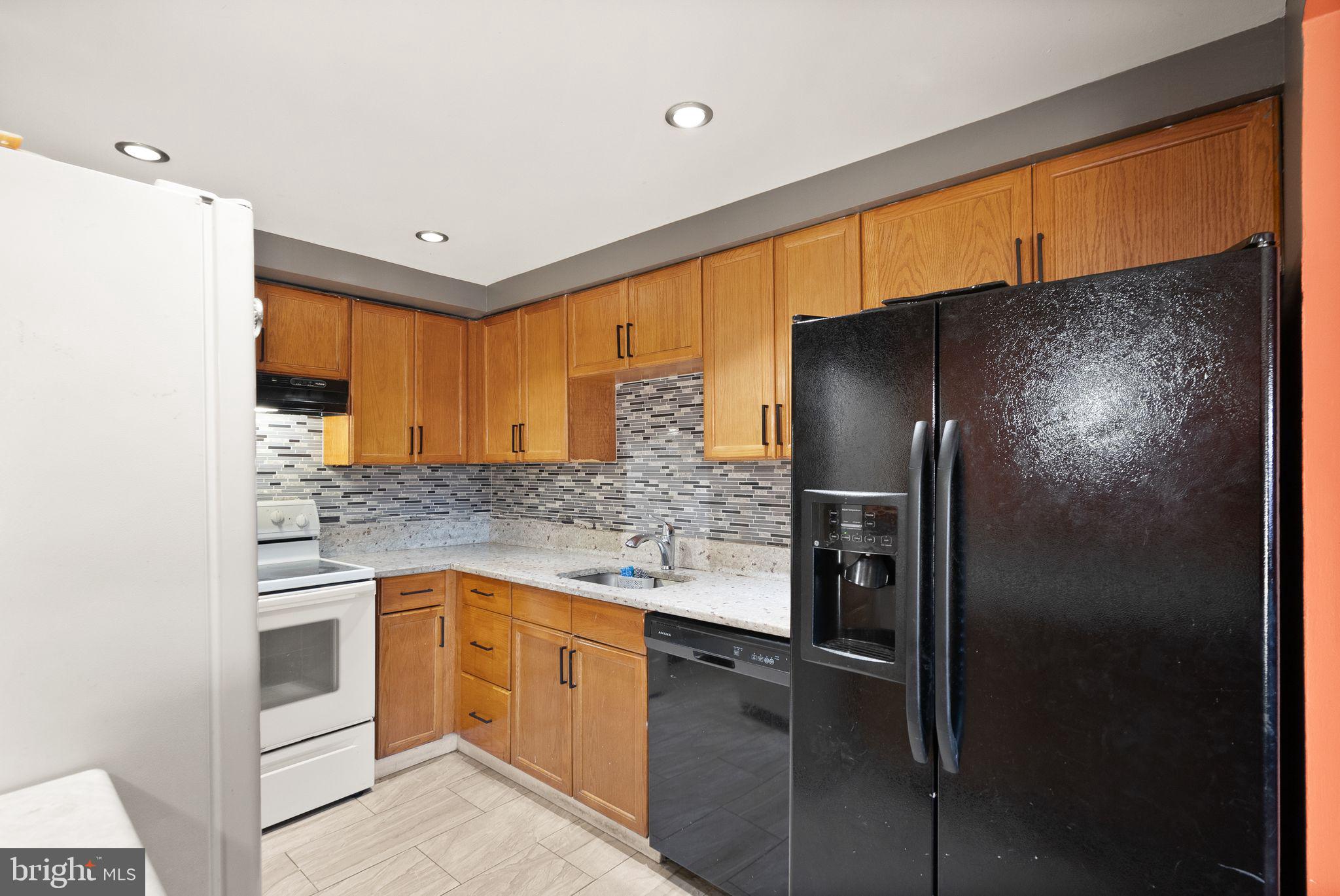 191 North Cottage Road Sterling, VA 20164 - Photo 12 of 41 a kitchen with stainless steel appliances granite countertop a refrigerator and a sink