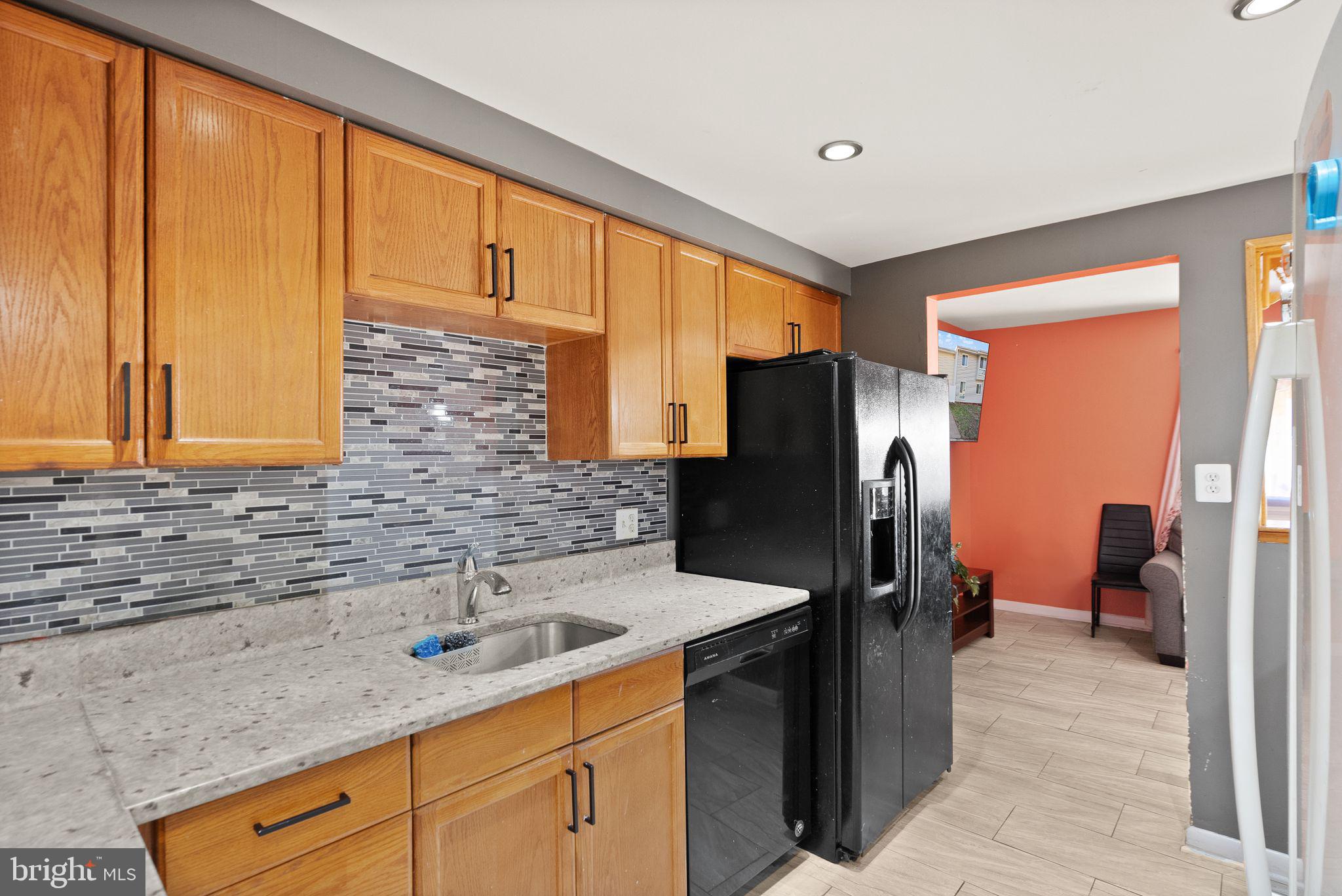 191 North Cottage Road Sterling, VA 20164 - Photo 13 of 41 a kitchen with stainless steel appliances granite countertop a refrigerator and a sink