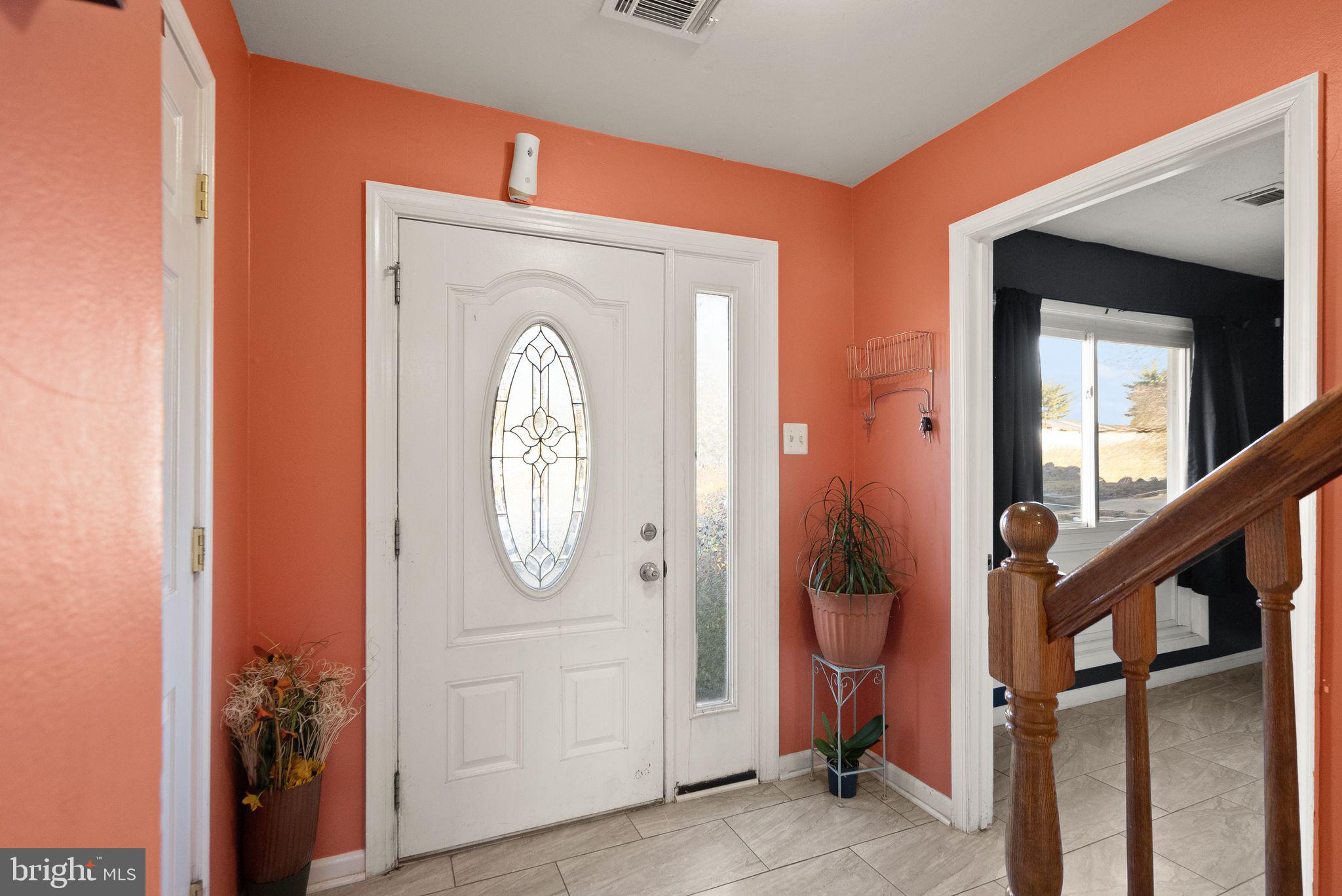 191 North Cottage Road Sterling, VA 20164 - Photo 5 of 41 a view of a hallway with entryway wooden floor and front door