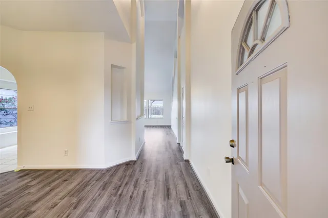 a view of a hallway with wooden floor