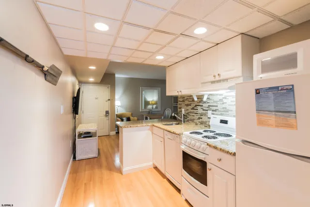 a kitchen with stainless steel appliances a stove a sink and a refrigerator