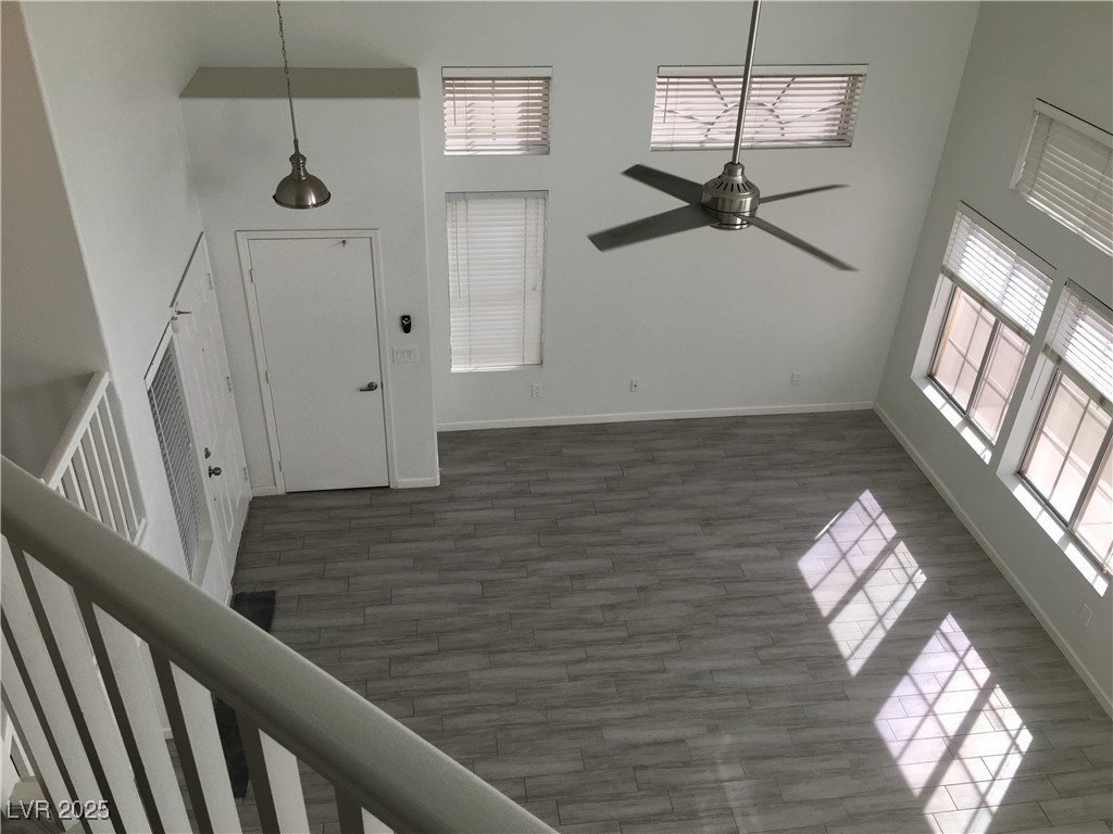973 Cedar Pines Street Henderson, NV 89011 - Photo 17 of 37 Entryway featuring a towering ceiling, ceiling fan, wood finished floors, and stairway