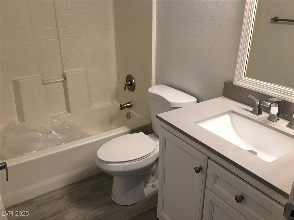 973 Cedar Pines Street Henderson, NV 89011 - Photo 29 of 37 Full bath with vanity, shower / tub combination, dark wood-style floors, and a textured wall