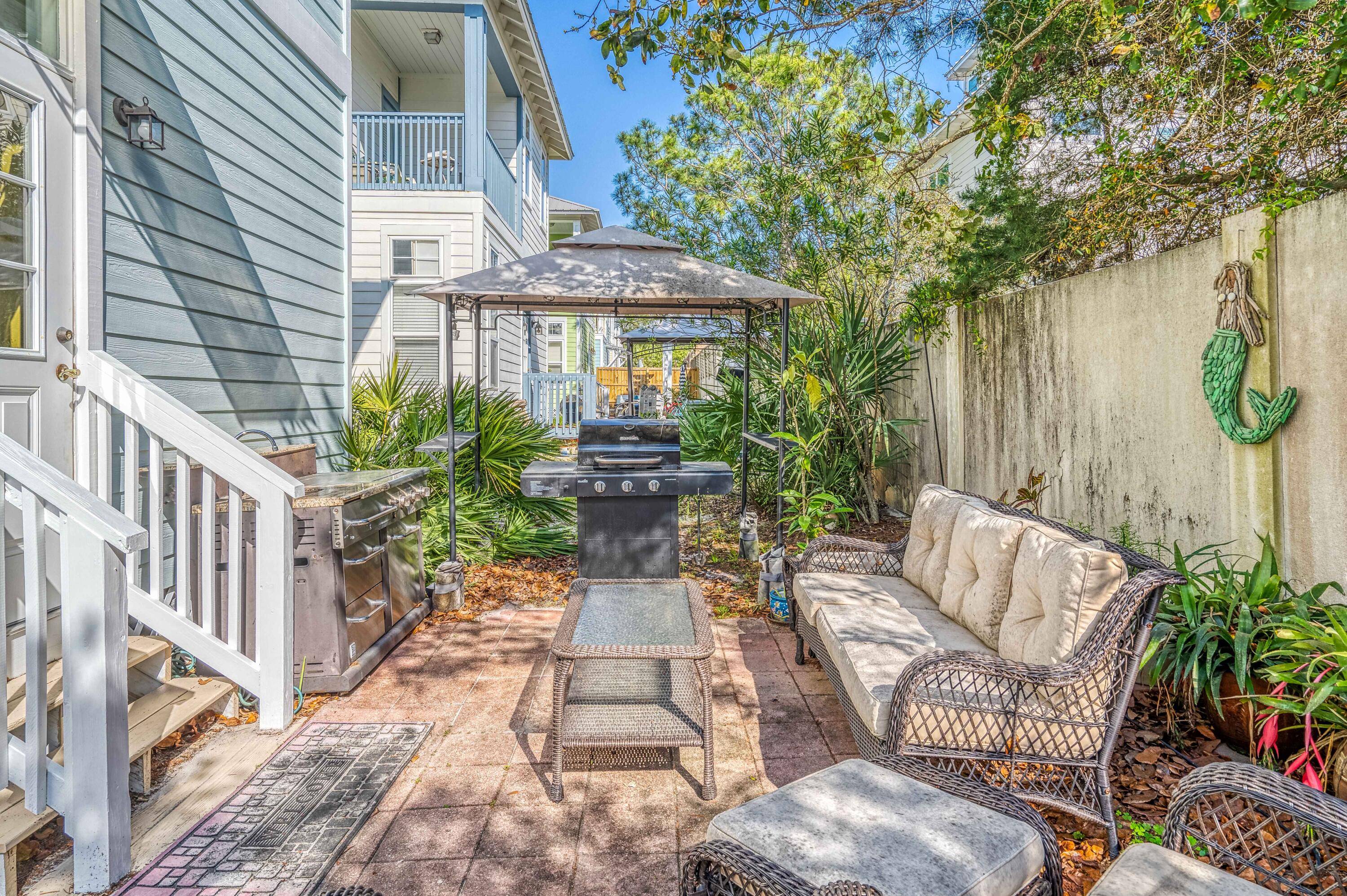51 Redfish Circle Santa Rosa Beach, FL 32459 - Photo 17 of 17 a view of a patio with couches table and chairs and potted plants