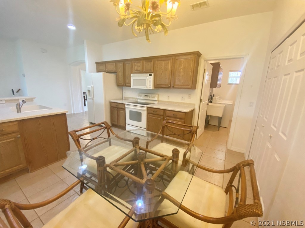 339 Mariners Gate Drive Edgewater, FL 32141 - Photo 19 of 30 a dining room with furniture and wooden floor