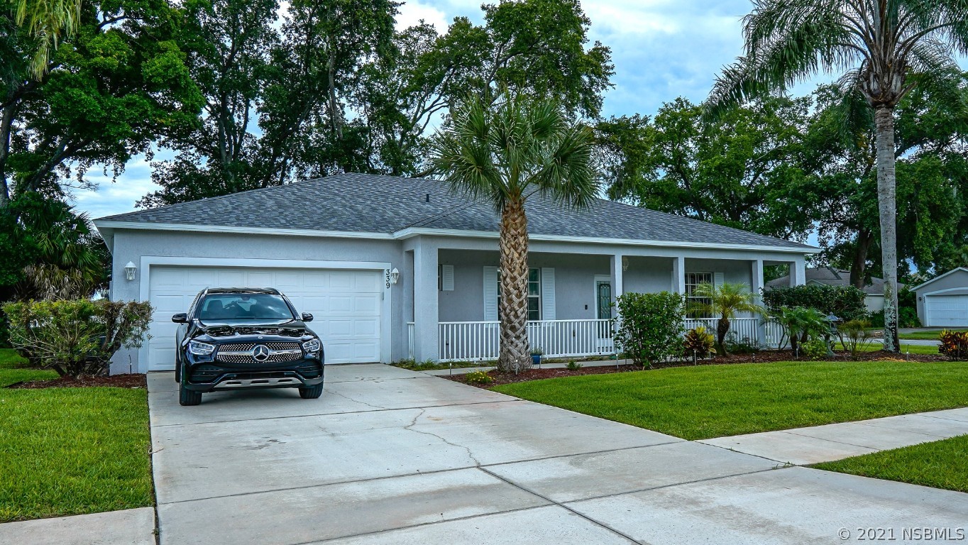 339 Mariners Gate Drive Edgewater, FL 32141 - Photo 2 of 30 a car parked in front of a house and a yard