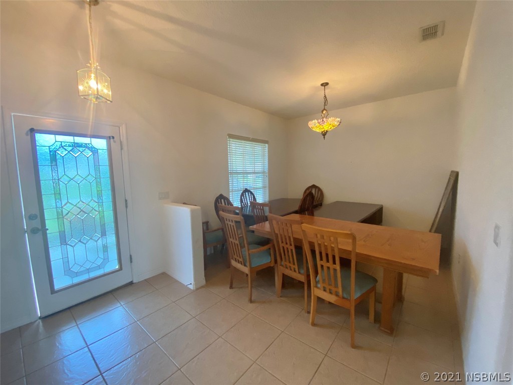 339 Mariners Gate Drive Edgewater, FL 32141 - Photo 22 of 30 a living room with furniture a lamp and a chandelier