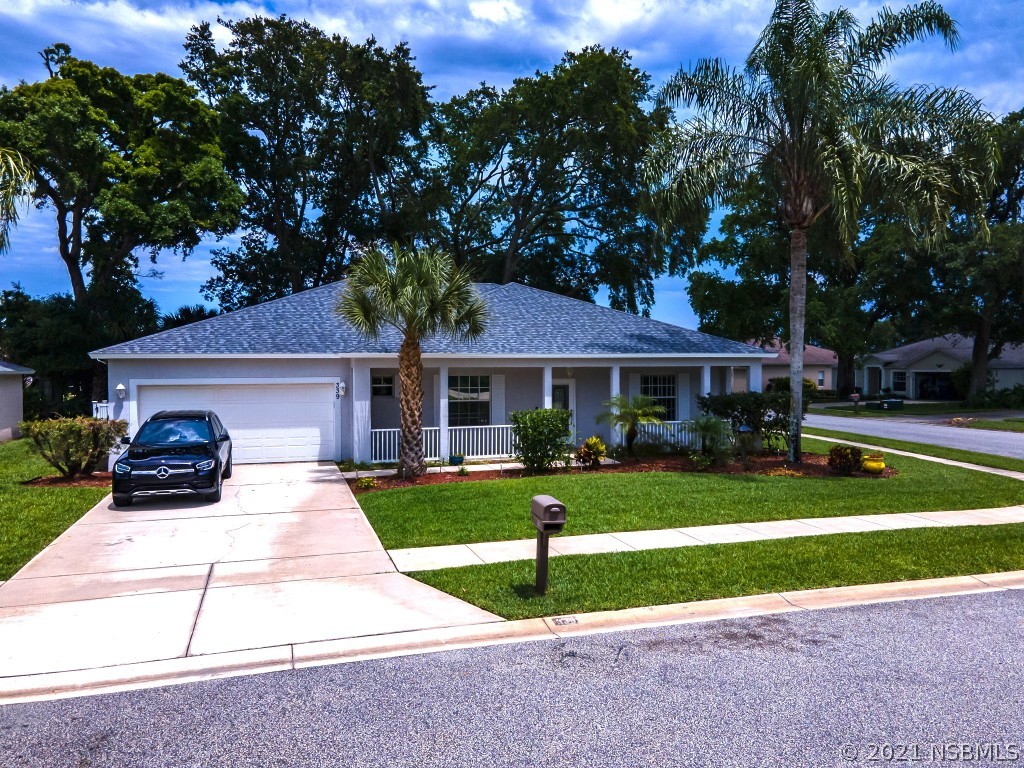 339 Mariners Gate Drive Edgewater, FL 32141 - Photo 3 of 30 a front view of a house with a yard and garage